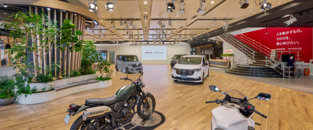 Multiple cars and motorcycles on display at Honda Welcome Plaza Aoyama