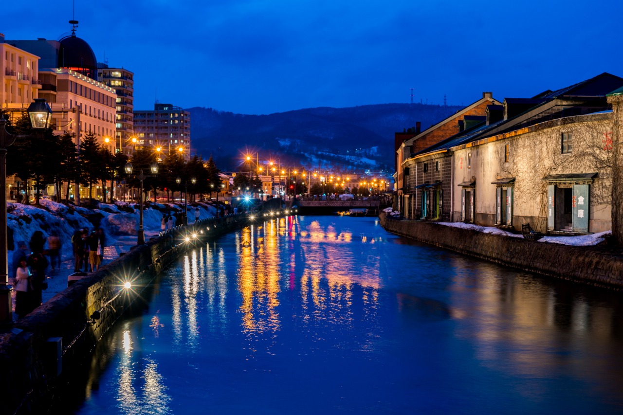 Canal and modern cityscape at night