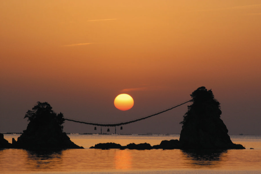 floating married rocks and a sunset over the sea