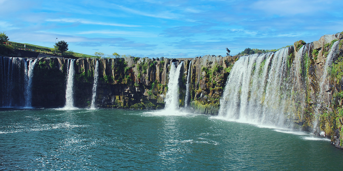 a majestic waterfall under the blue sky