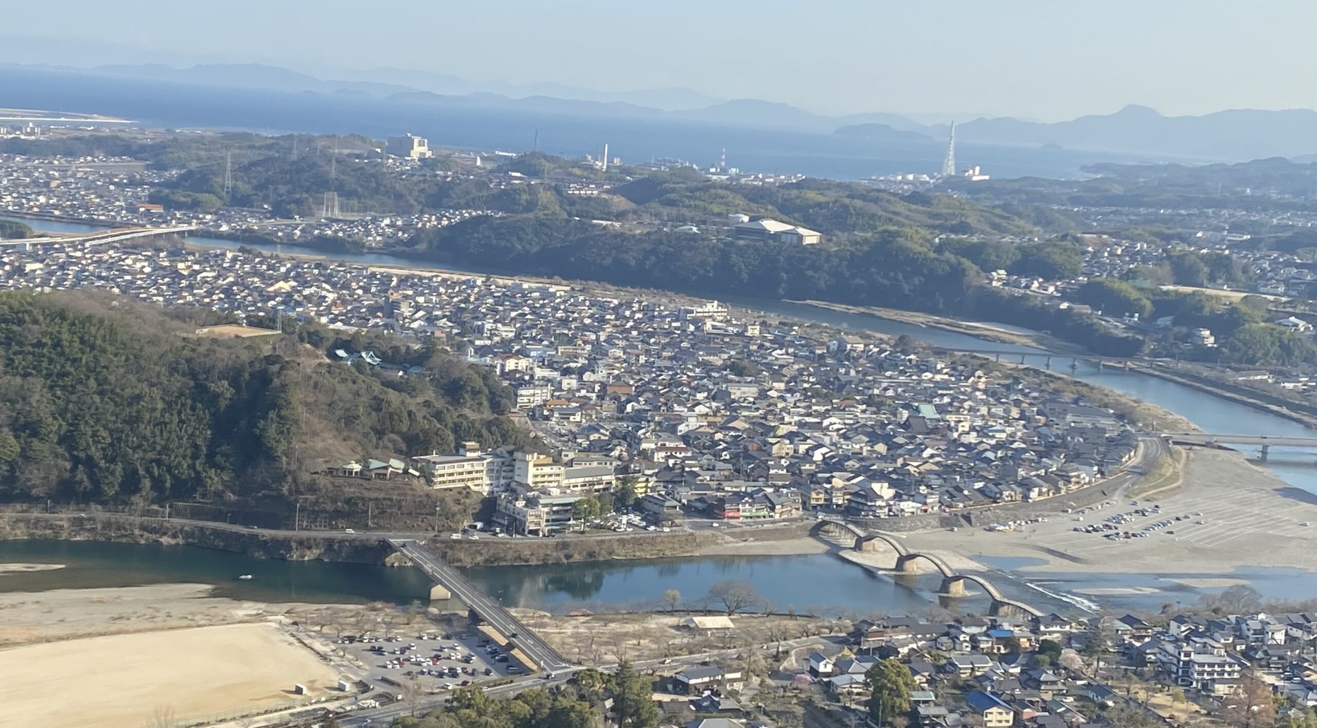 A panoramic view of Yamaguchi cityscape with rivers and bridges intersecting