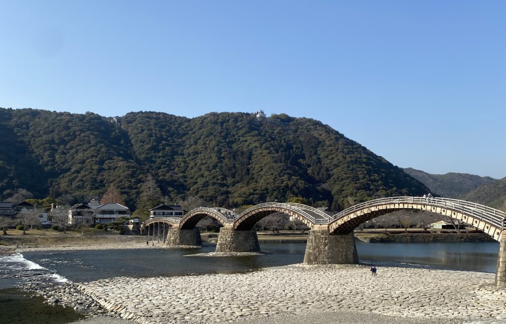 Kintaikyo Bridge, a beautiful wooden structure with a lush green backdrop