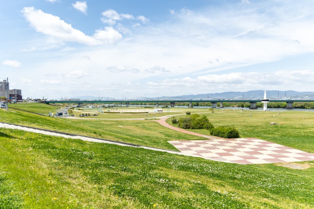 Spacious green space and a bridge in the distance