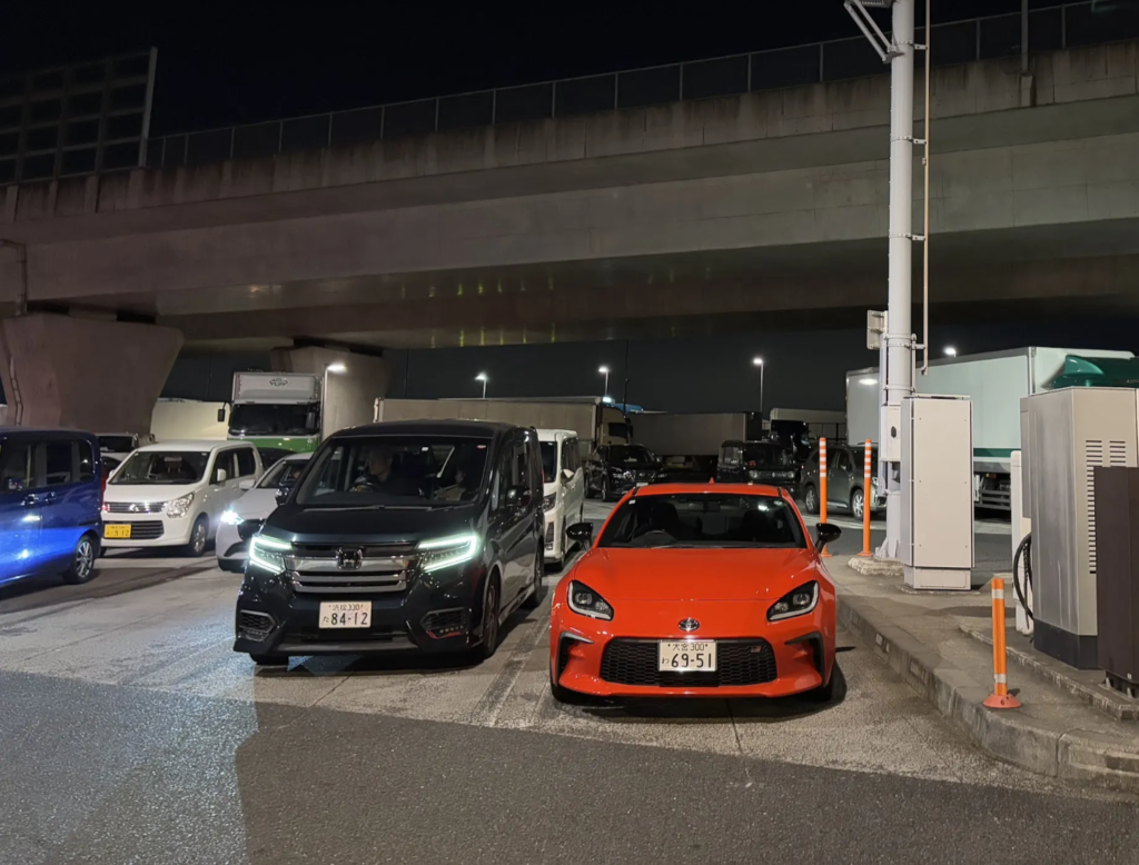 Night parking lot with Toyota GR86 and other vehicles