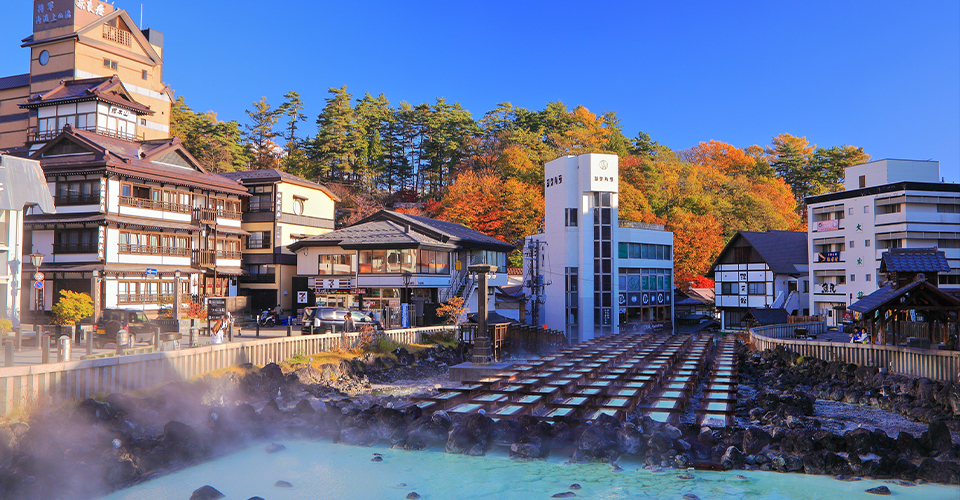 Yubatake hot water field at Kusatsu Onsen with scenic surroundings