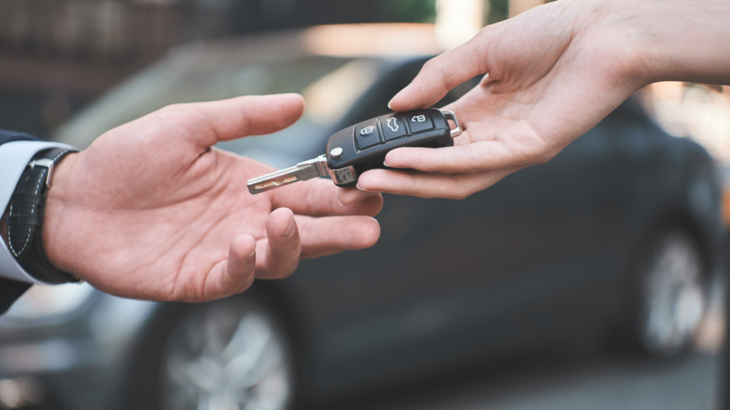 Hands exchanging car keys