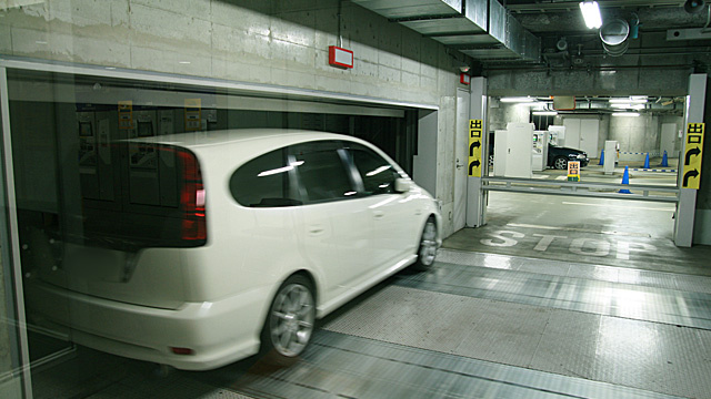 Japanese mechanical parking garage entrance with white car