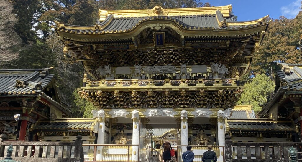 Toshogu Shrine ornate golden Yomeimon Gate traditional Japanese architecture in Nikko visitors climbing steps