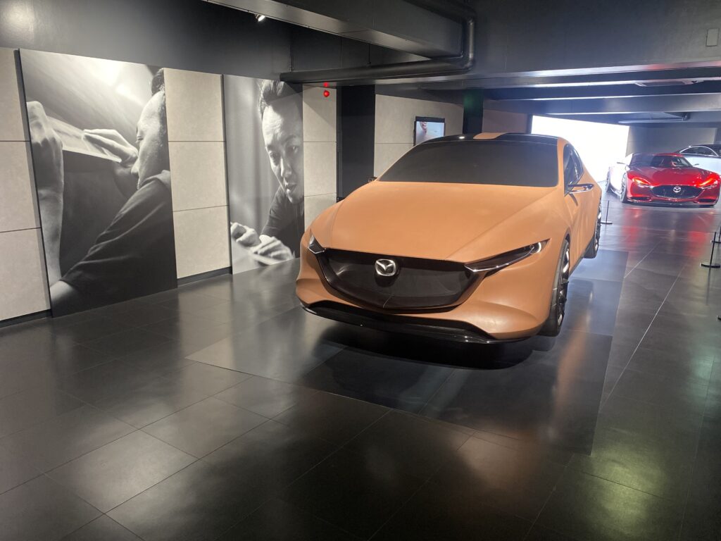 The orange model car on display at the Mazda Museum
