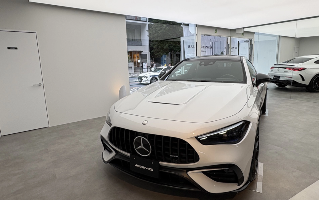 White Mercedes-AMG CLA with aggressive front grille and Panamericana design on display