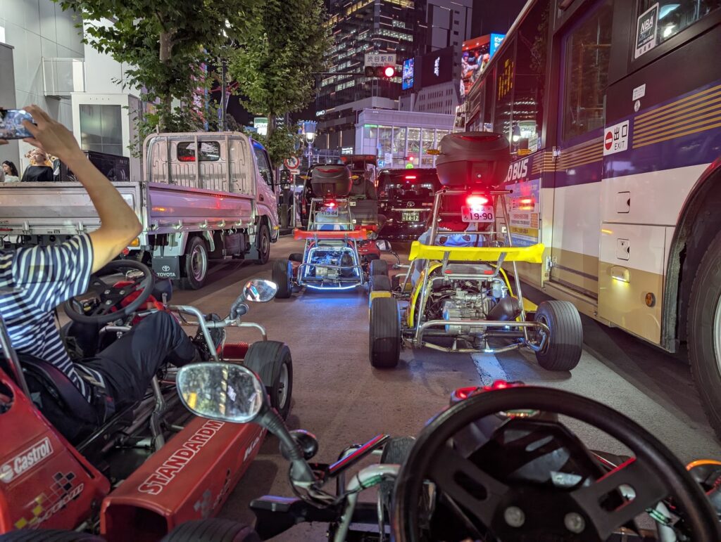 Driving a go kart through Shibuya Station traffic at night in Tokyo