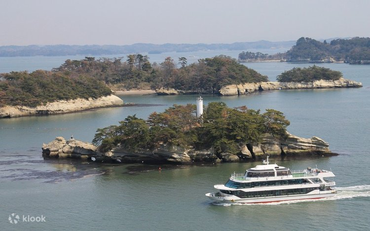 Sightseeing boat cruising past pine-covered islands in Matsushima Bay
